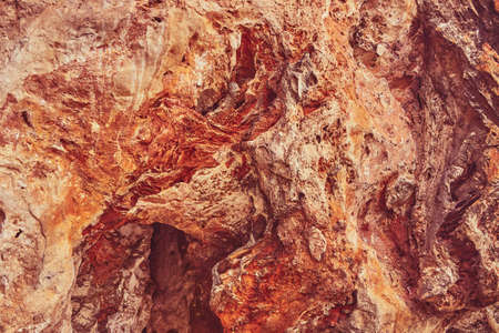 Red stone cave wall as background or backdrop.の写真素材