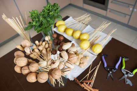 Everything is prepared to create a fruit bouquet of mint, lemons and nutsの写真素材