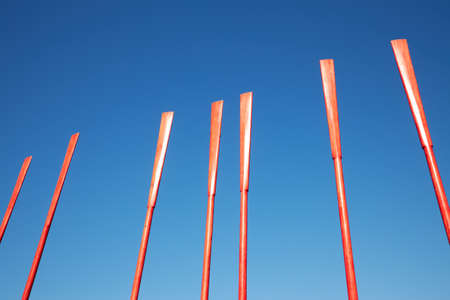 Several red oars against a blue sky on a sunny dayの写真素材