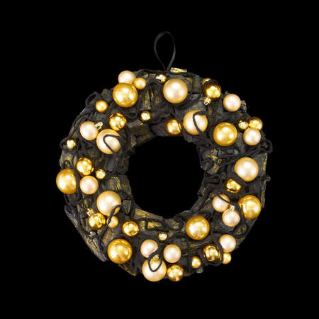 Black coal ring decorated with shoelaces and gold balls as an element of the interior on a black backgroundの写真素材
