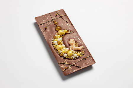 Handmade milk chocolate bar with crescent moon and angel figureの写真素材