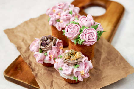 Delicious cupcakes decorated with cream and handmade pink marshmallowsの写真素材