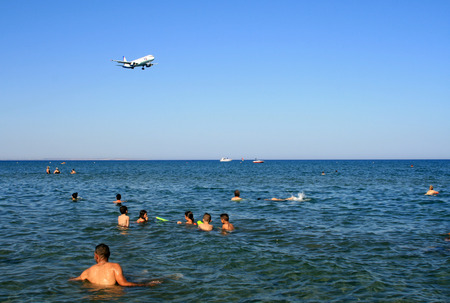 Larnaca, Cyprus, June 25th, 2017: An airplane passing over Mackenzie Beach to Larnaca International Airportのeditorial素材
