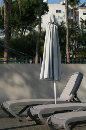 Empty sun bed and umbrellaの写真素材