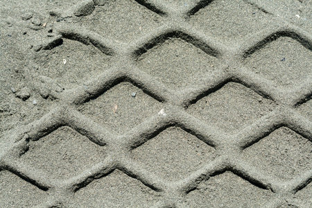 Texture of distinct tire tracks in the sandの写真素材