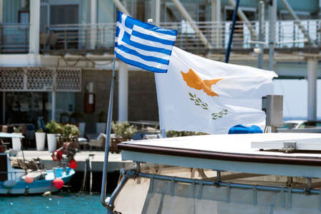 Greek and Cypriot national flags at sea harborの写真素材