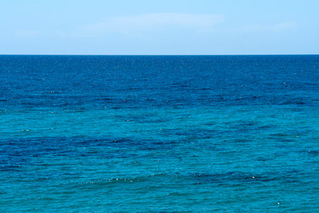 Background of different shades of blue sea water surface and sky