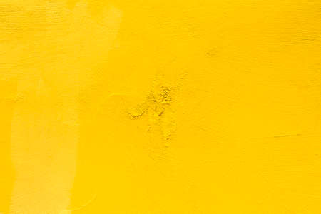 Texture of bright yellow painted concrete wallの写真素材