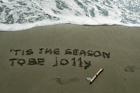 Line from Christmas carol on beach sandの写真素材