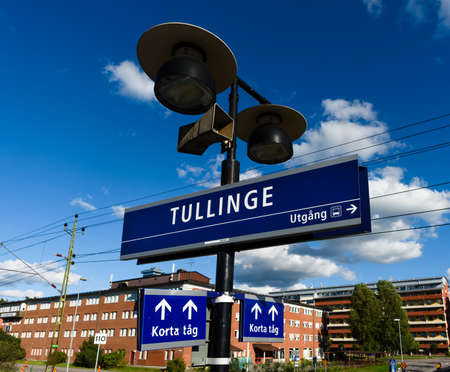 Tullinge, Sweden - August 12, 2015: Tullinge train station with the station sign, speaker, sign show exit direction to bus, also sign for short trainのeditorial素材