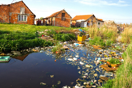 Settlement through which the river that is polluted with various garbage, Polluted rivers, photographyの写真素材