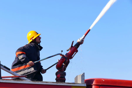 Firefighter with a water cannon / Firefighter with a water cannon extinguishes a fire