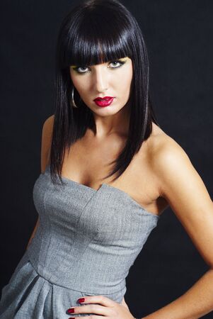 pretty brunette woman posing on dark background - close upの写真素材