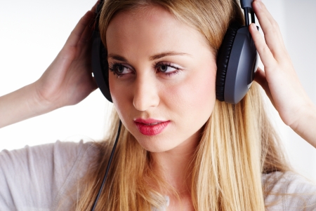 nice blond woman listening to the music on headphonesの写真素材
