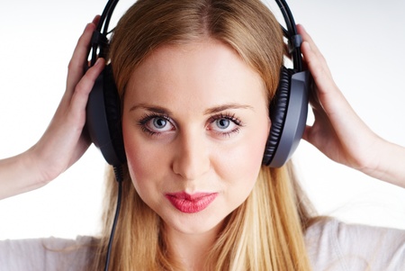 nice blond woman listening to the music on headphonesの写真素材