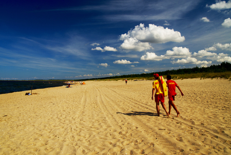 Lifeguards walking at the seasideの写真素材