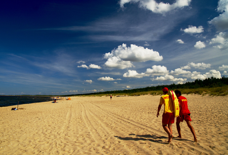 Lifeguards walking at the seasideの写真素材