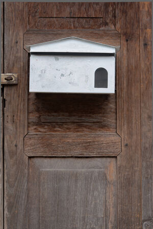 White Letterbox on Old Woodの写真素材