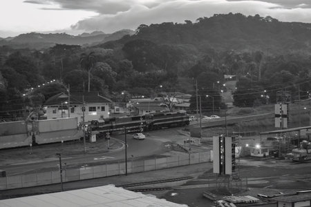 A black and white photo of a train station with a train in the foregroundの写真素材