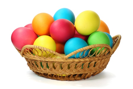 Multi-colored Easter eggs in the basket isolated on white の写真素材