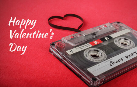Vintage audio cassette with loose tape shaping a heartの写真素材