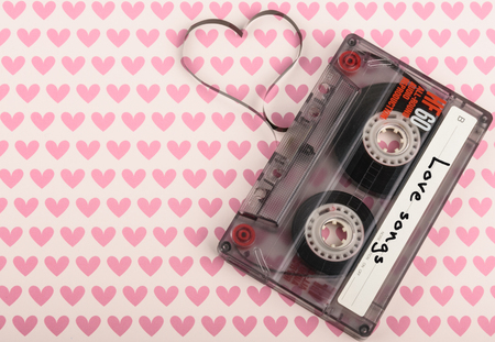 Vintage audio cassette with loose tape shaping a heartの写真素材