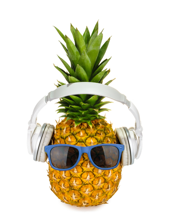 Pineapple fruit in a glasses with headphone isolatedの写真素材