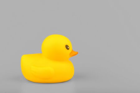 yellow rubber duck on grey backgroundの写真素材