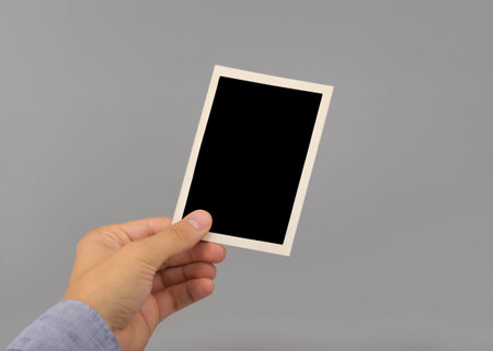 hand holding blank photo frame 