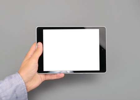 blank tablet computer on gray background