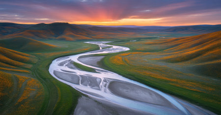Serene Winding River Through Rolling Hills at Sunsetの素材