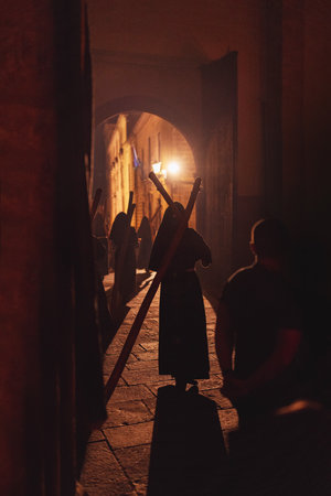 Penitents walking with wooden cross on their shouldersの写真素材