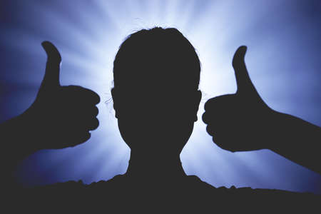 Hands holding their thumbs up, faceless anonymous woman, mystic background, gesture of like, like button, influenced by social media, call to action concept.の写真素材