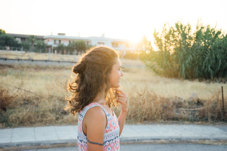 Young girl, teenager, portrait, sun at sunset, summerの写真素材