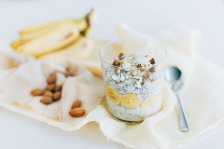 breakfast, oatmeal with banana and almons  in a glassの写真素材
