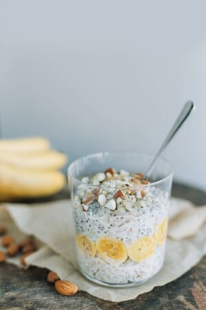 breakfast, oatmeal with banana and almons  in a glassの写真素材