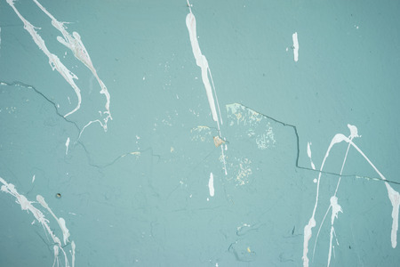 Textured painted turquoise wall with white blotsの写真素材