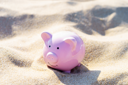 Ceramic pink pig on the sand on a Sunny day. The concept of recreation and tourism 2019.の写真素材