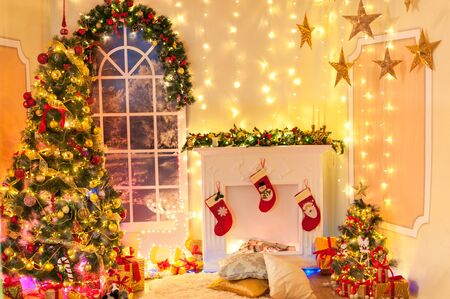 Christmas decoration in  room interior with fireplace, classic new year tree with presentsの写真素材