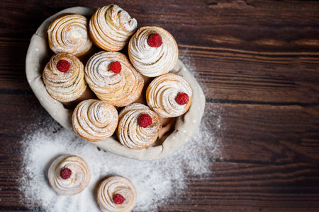 Modern trend baking in 2020-cruffins, puffmuffin, a mixture of croissants and muffins. On a dark...