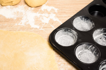 rolled dough with butter on the table with a rolling pin for rolls and rolls. next to it is a...