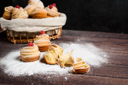 modern cruffins are made from puff croissants in the form of a muffin. on a dark background in powdered sugar. Copy space. the view from the top. close up.の写真素材