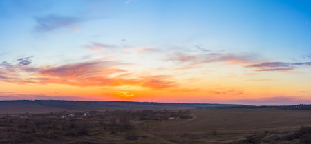 panorama of a blue-pink sunset with clouds of pink hues. sunset on the horizon. dramatic sky. photo for the banner. space for text.の写真素材