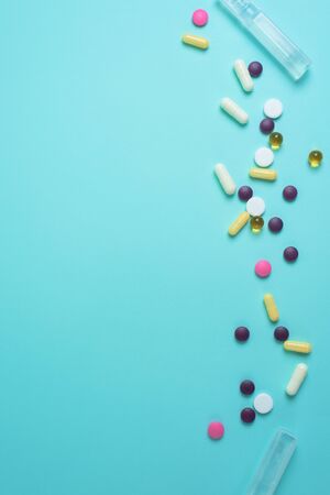 coronavirus tablets top view. background image. capsules and tablets with blisters on a blue background. treatment of infection during a pandemic.の写真素材