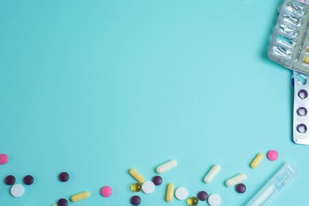 coronavirus tablets top view. background image. capsules and tablets with blisters on a blue background. treatment of infection during a pandemic.の写真素材
