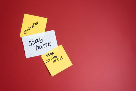 text-coronavirus, stay at home, office at home written on yellow sheets of paper by hand. the view...