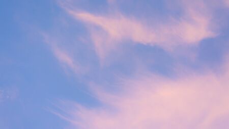 pink pastel clouds at sunset blue sky. abstract photo, background imageの写真素材
