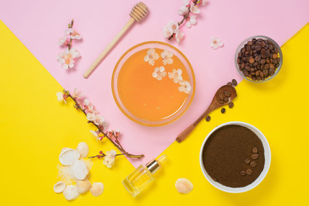 natural organic ingredients-sea salt, coffee scrub, honey and a hard body brush on a yellow background. home skin care for cellulite. concept of skin care, home Spa. the view from the topの写真素材