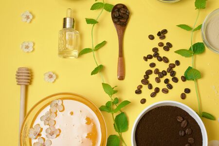 natural organic ingredients-sea salt, coffee scrub, honey and a hard body brush on a yellow background. home skin care for cellulite. concept of skin care, home Spa. the view from the topの写真素材
