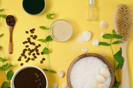 natural organic ingredients-sea salt, coffee scrub, honey and a hard body brush on a yellow background. home skin care for cellulite. concept of skin care, home Spa. the view from the topの写真素材